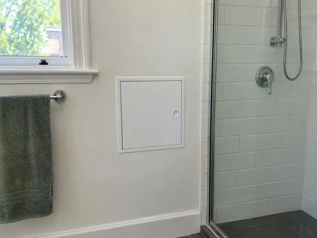 Neat access panel in a bathroom wall beside a shower and towel rail in Pymble